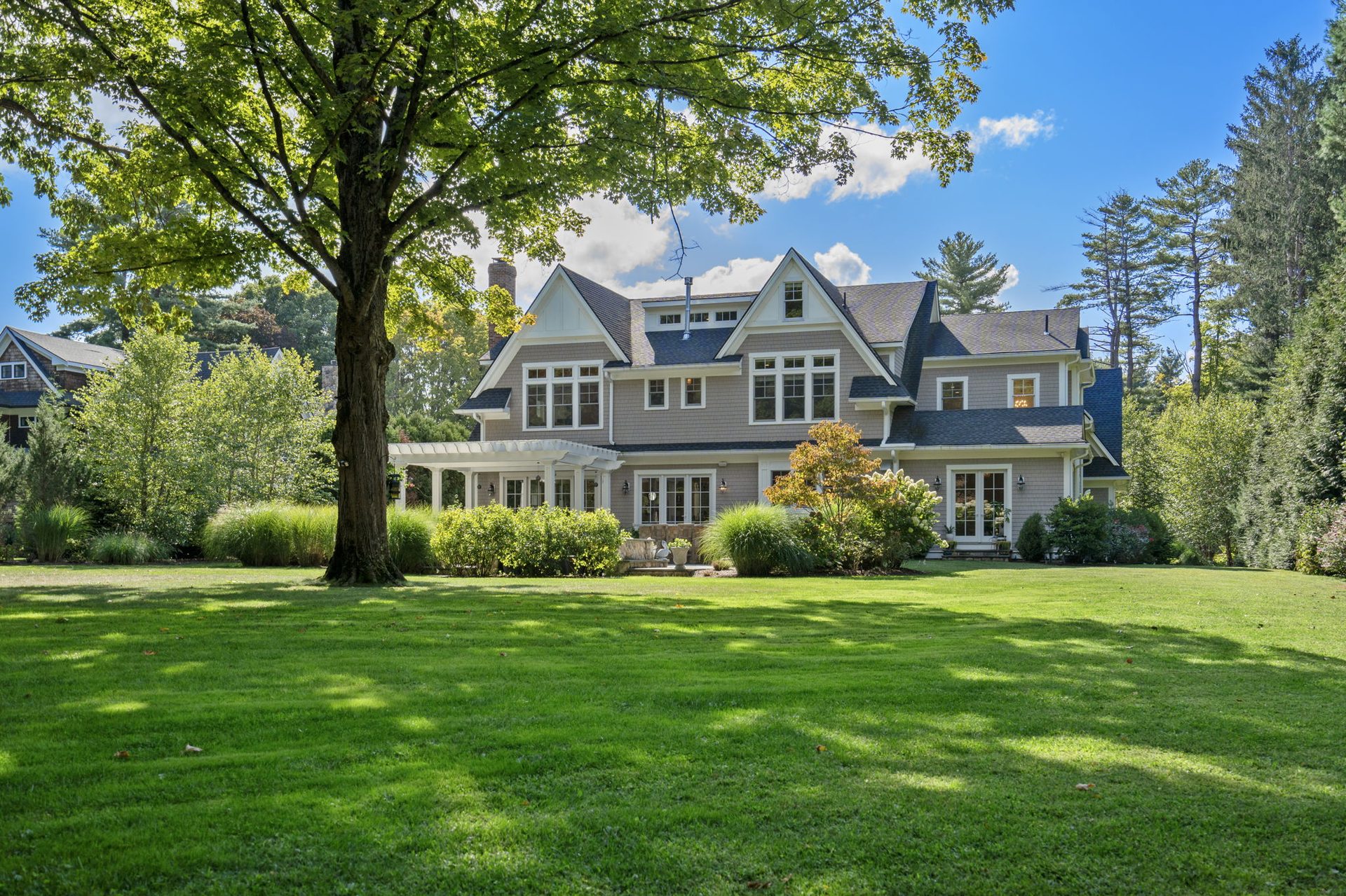 Shingle-style home on a wide lawn west of Boston